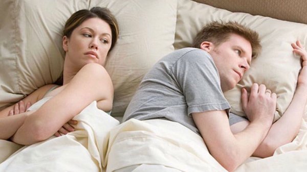 Couple thinking in bed